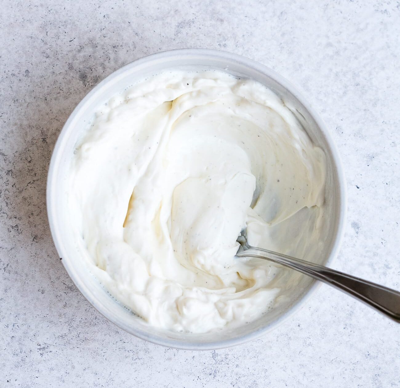 Cream cheese, half and half and spices whisked together in a bowl.