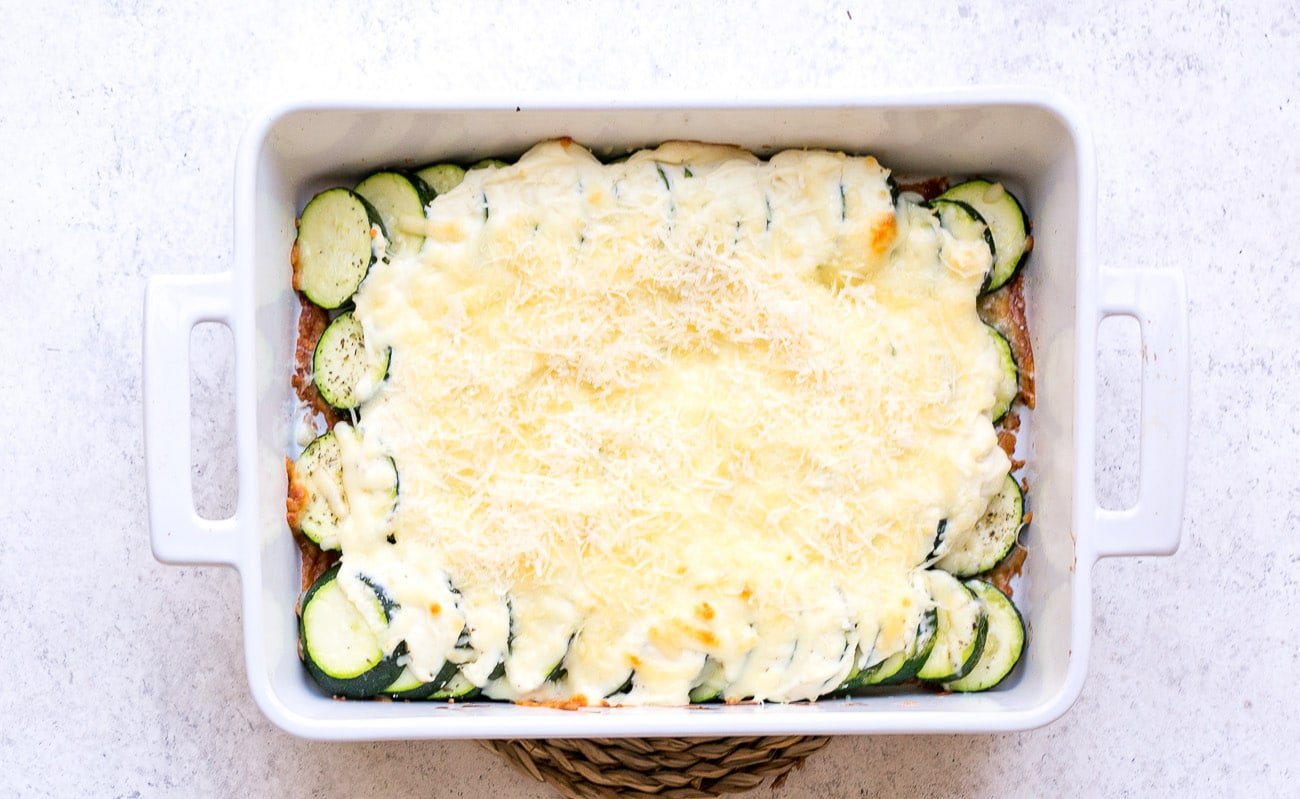 Parmesan cheese added to baked casserole before returning to the oven for broiling.