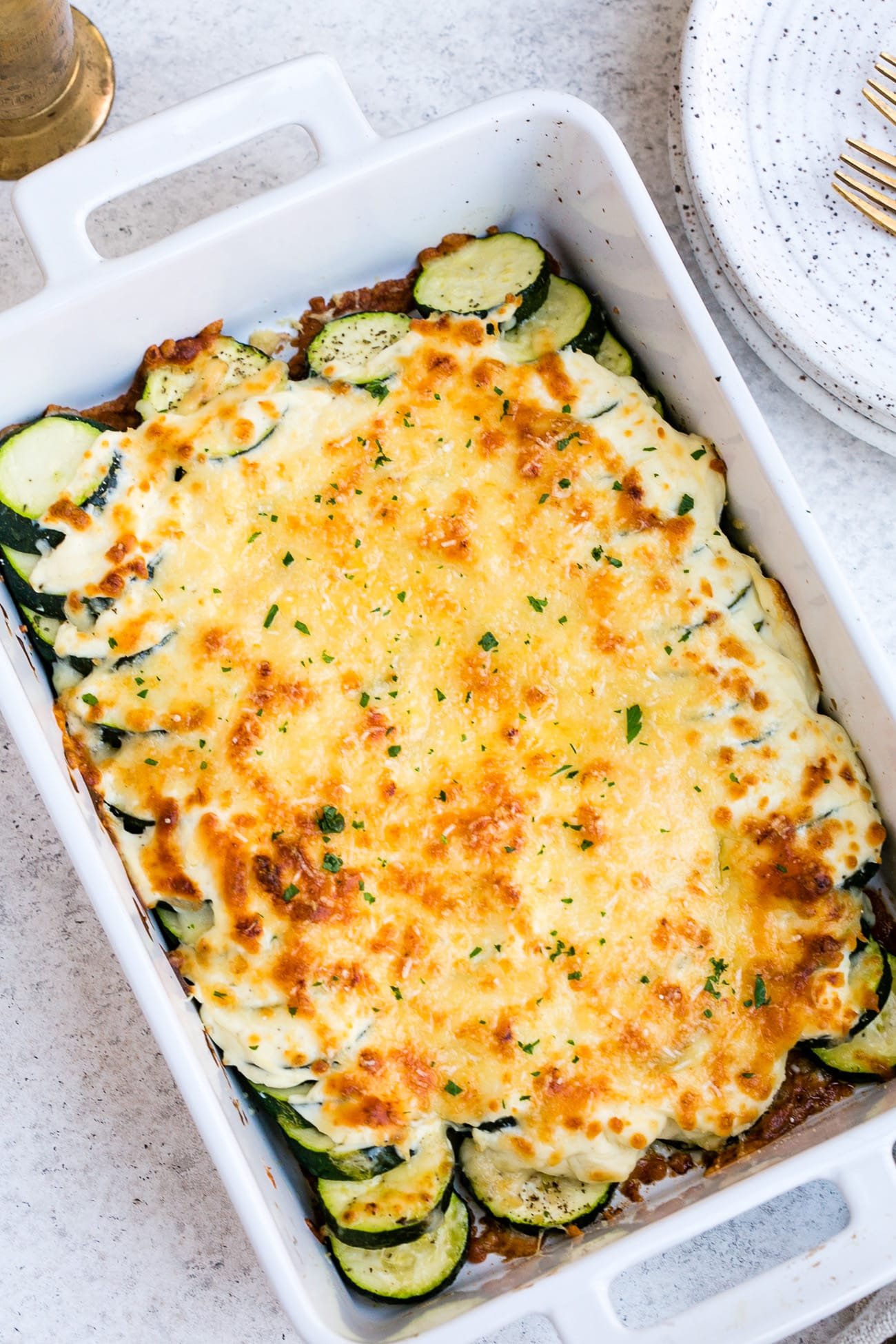 Zucchini casserole in a large, white baking dish.