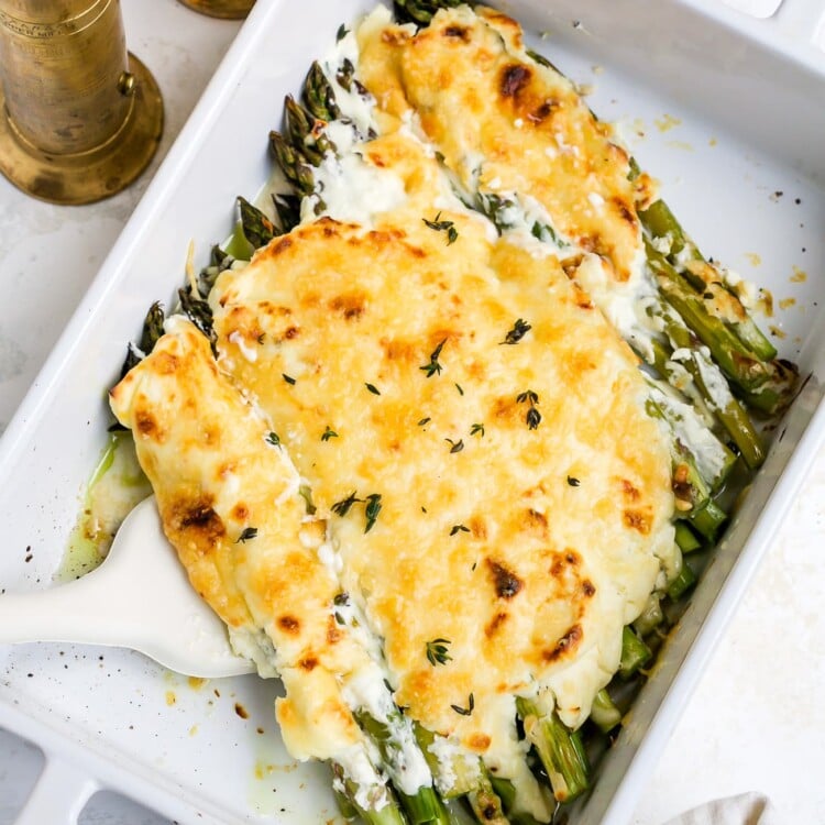 Asparagus casserole in a white baking dish.