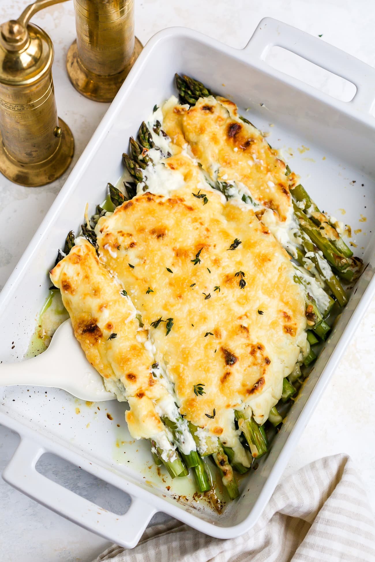 Asparagus casserole in a white baking dish.