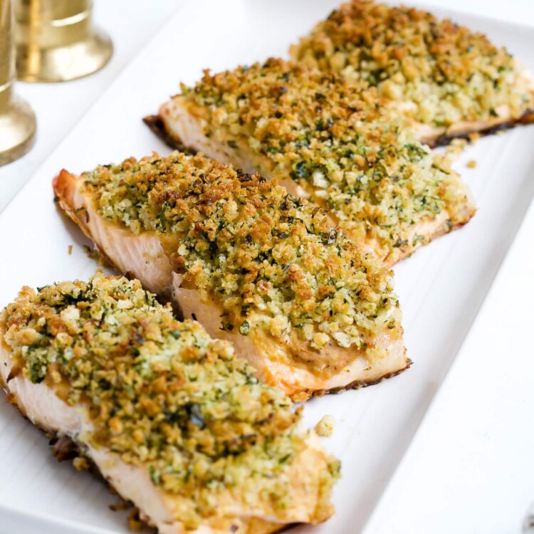 Panko crusted salmon on a white serving plate.