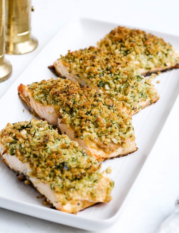 Panko crusted salmon on a white serving plate.