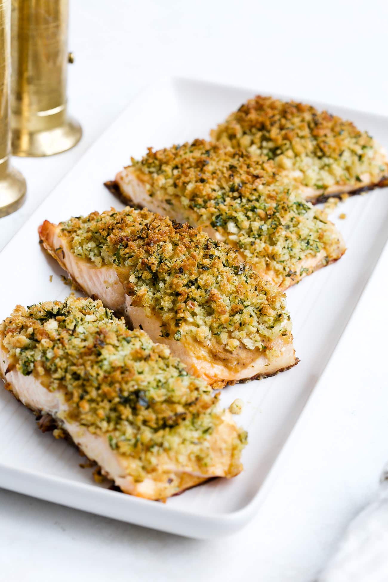 Panko crusted salmon on a white serving plate.