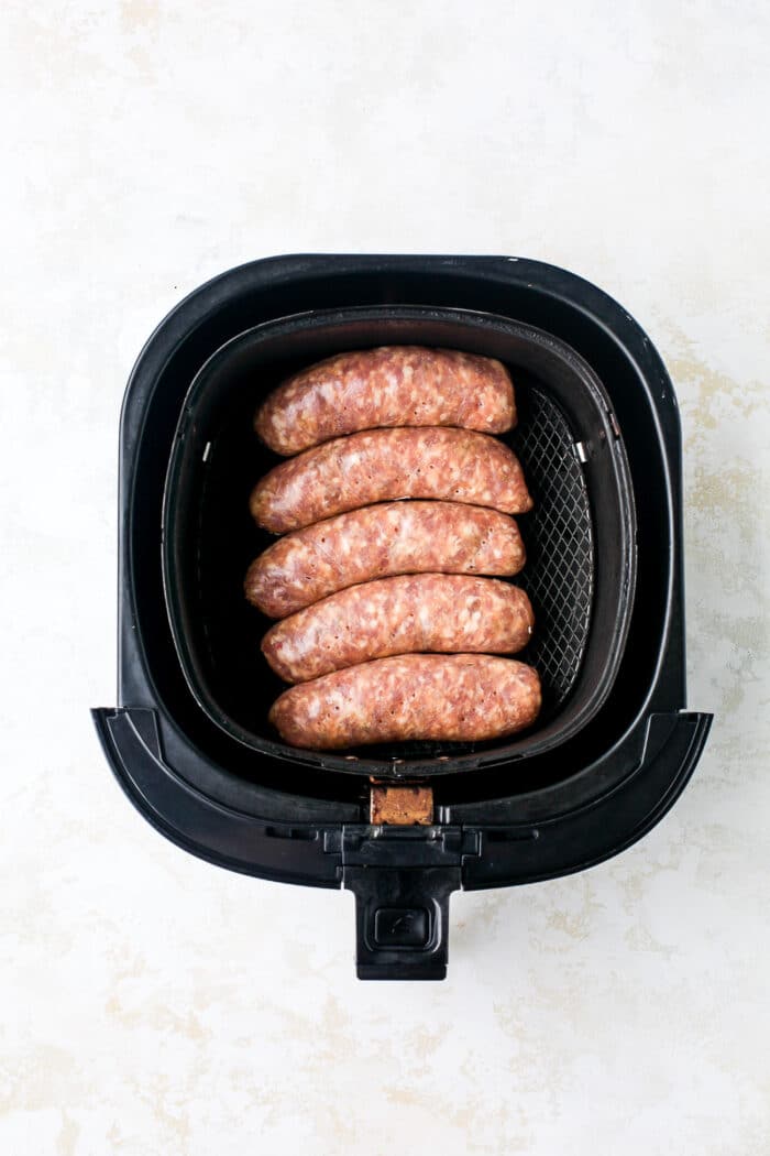 Sausages placed in air fryer.