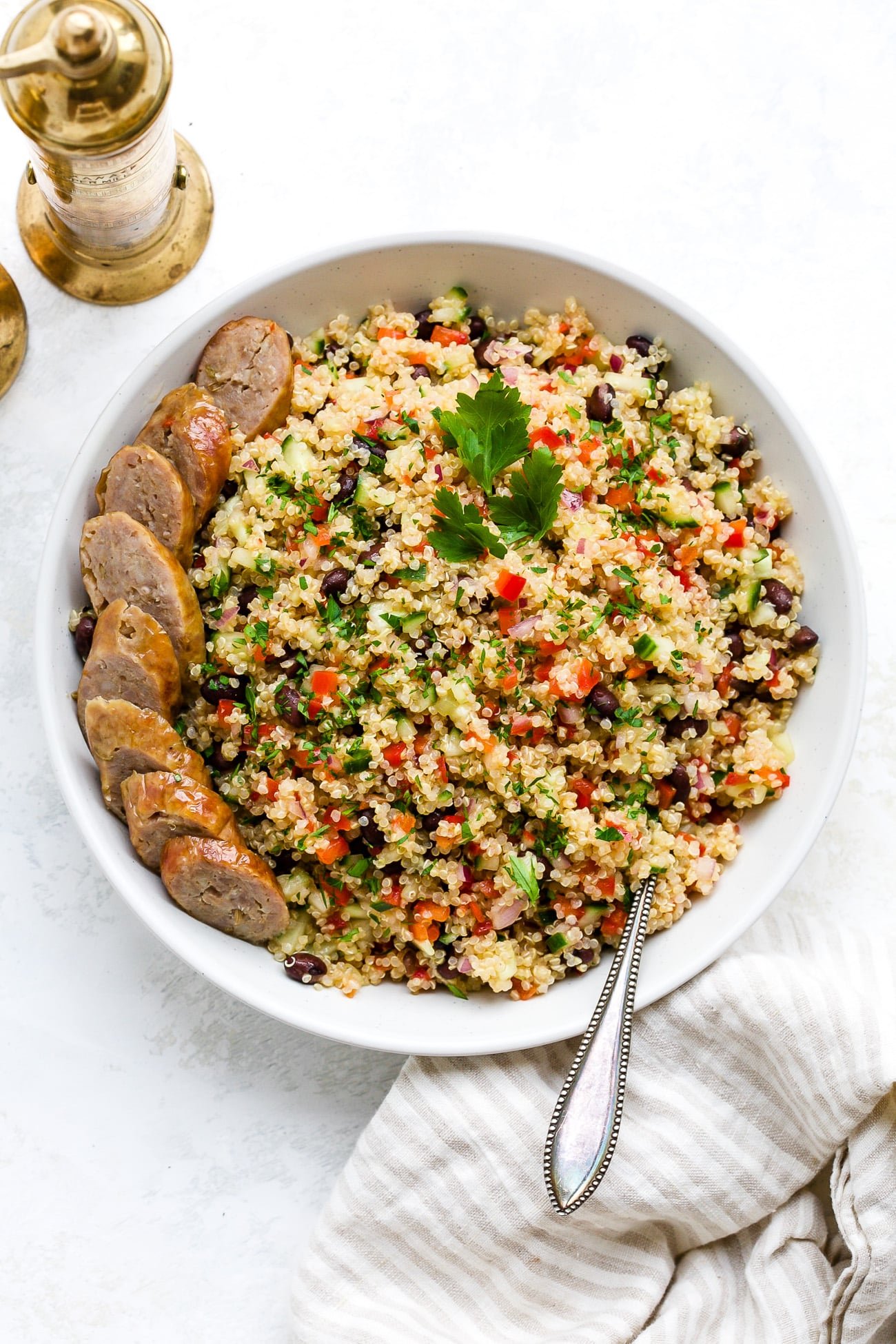 Quinoa salad in a large, white serving bowl. 