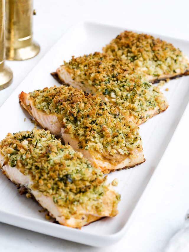 Panko crusted salmon on a white serving plate.