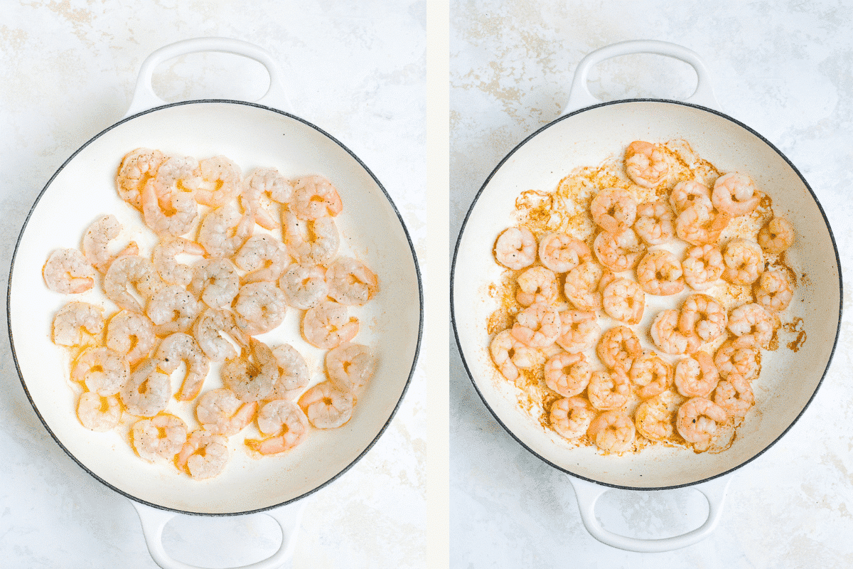 Overhead view of cooked shrimp in a white cast-iron braising skillet