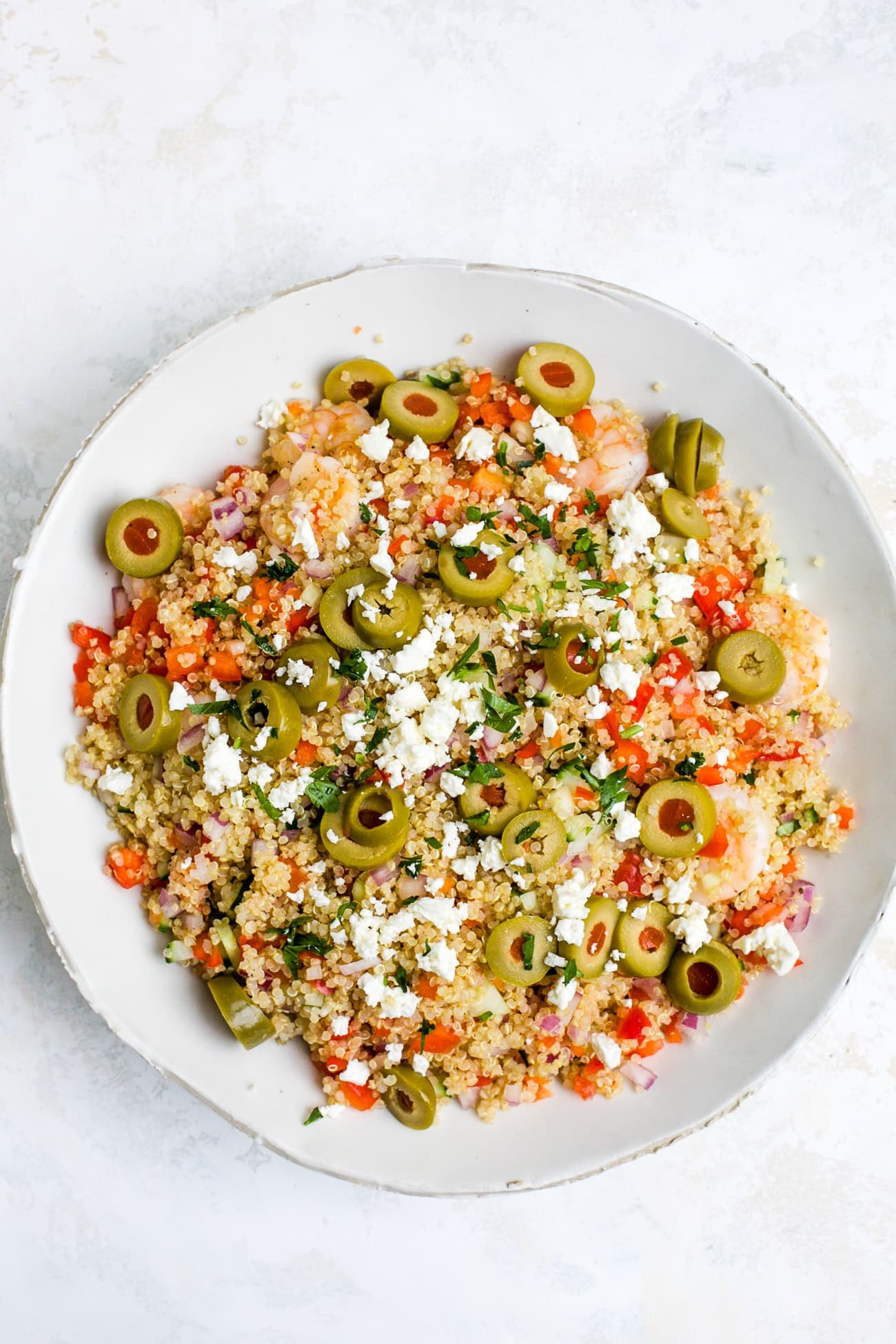 Overhead view of shrimp quinoa salad in a white bowl.