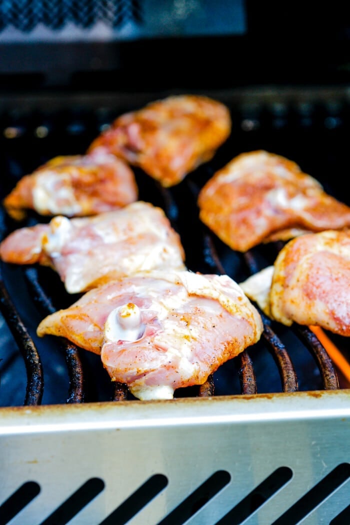 raw chicken thighs on the grill