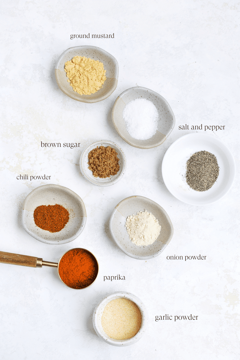 all the ingredients for a bbq seasoning on small little pots