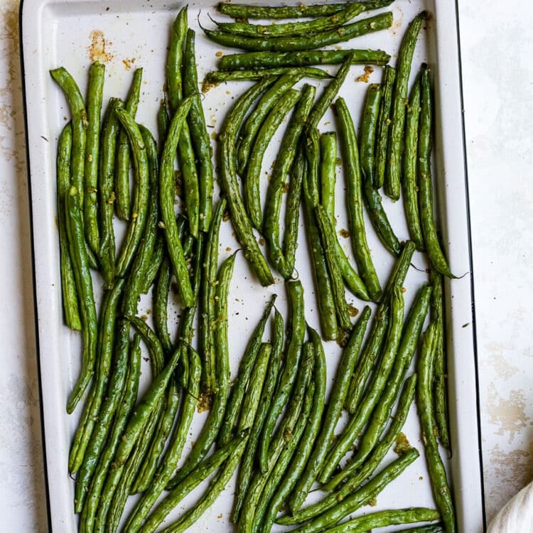 Roasted green beans on a baking sheet.