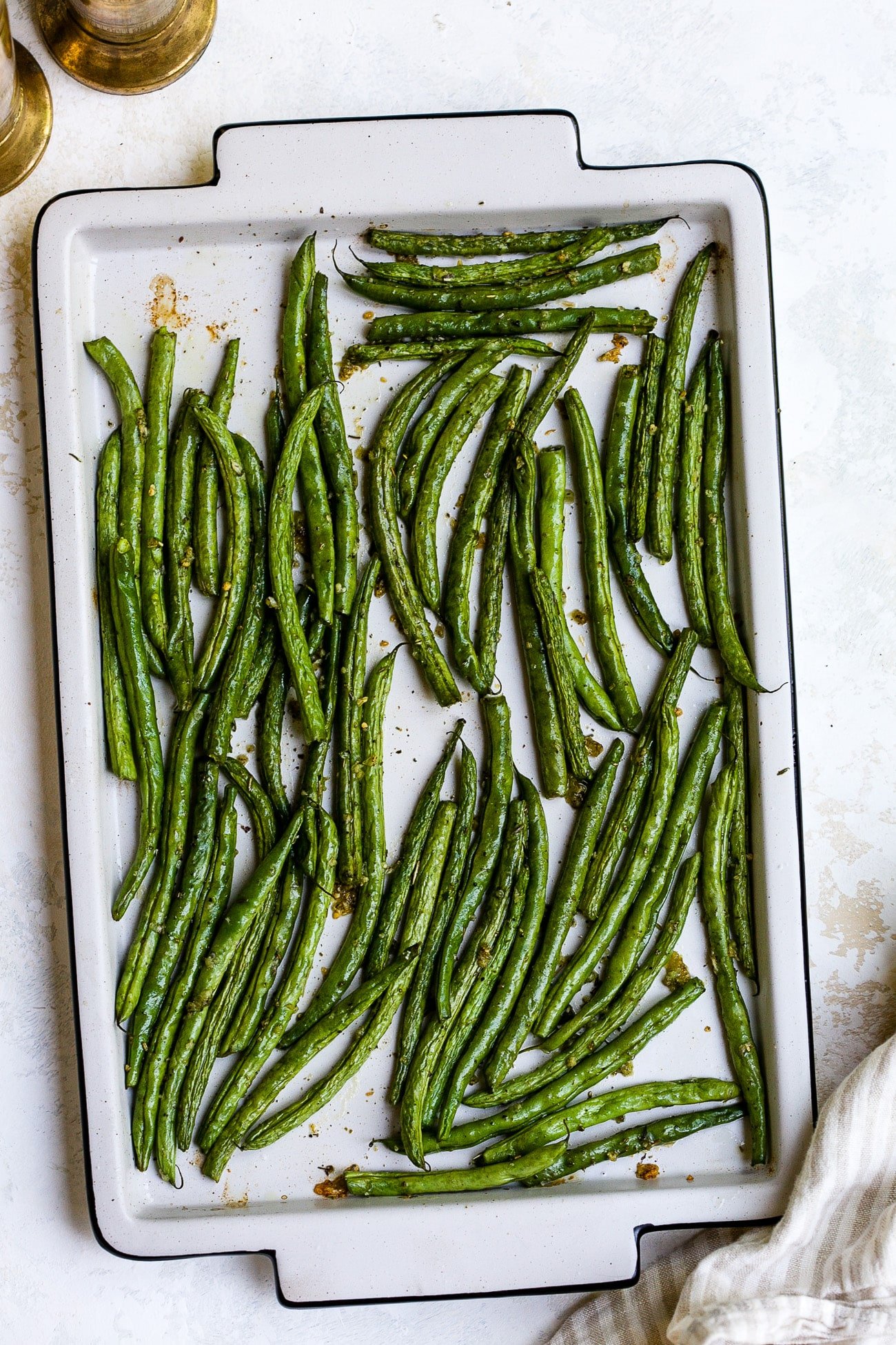 Roasted green beans on a baking sheet.