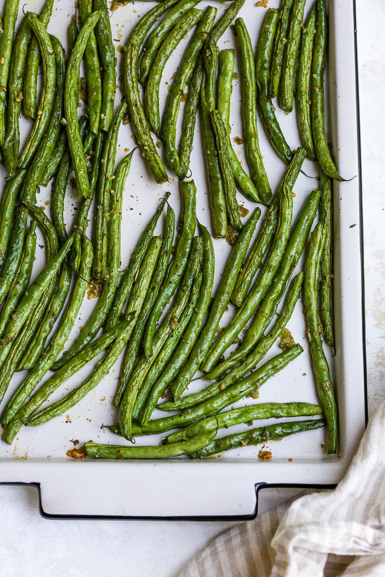 Roasted green beans on a large baking sheet. 