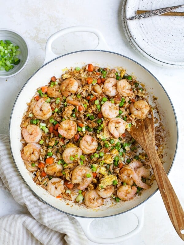 overhead view of shrimp fried rice in a white skillet.