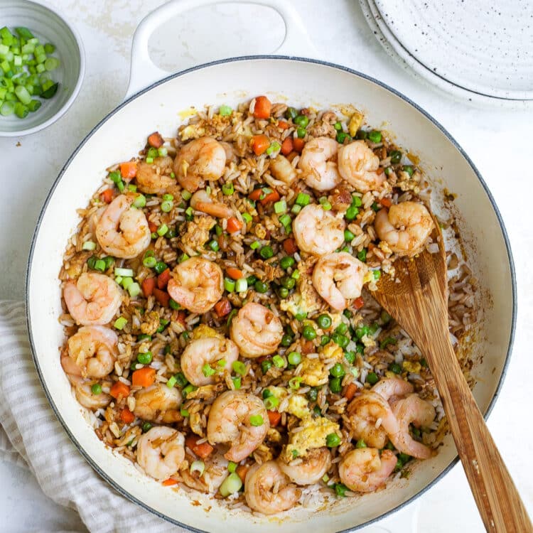 overhead view of shrimp fried rice in a white skillet.