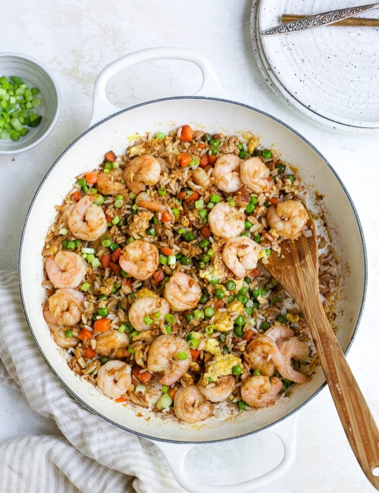 overhead view of shrimp fried rice in a white skillet.