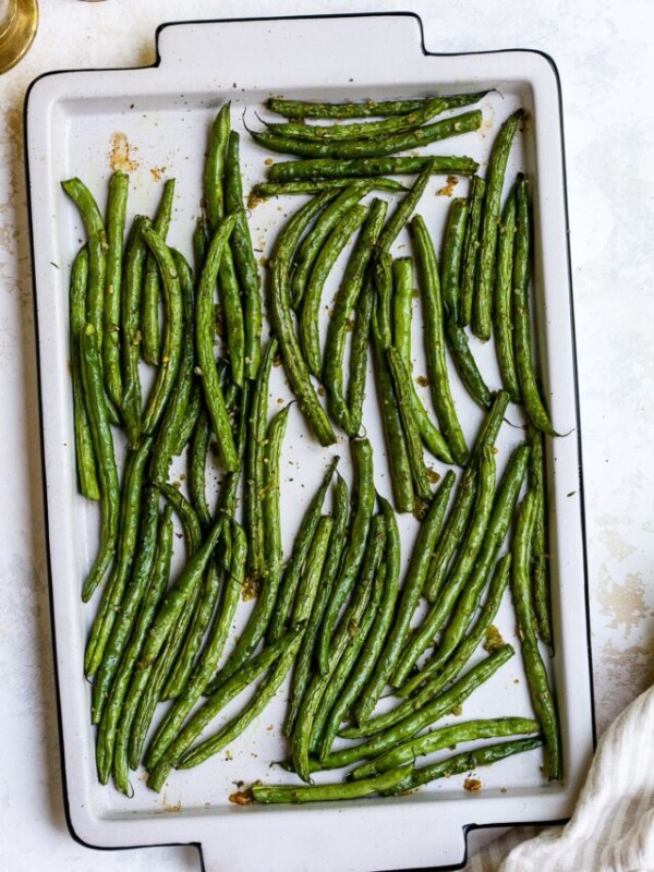 Roasted green beans on a baking sheet.