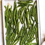 Roasted green beans on a baking sheet.