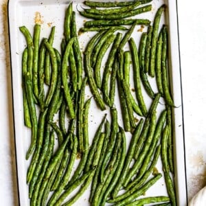 Roasted green beans on a baking sheet.