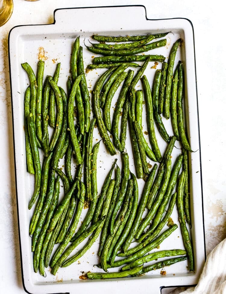 Roasted green beans on a baking sheet.
