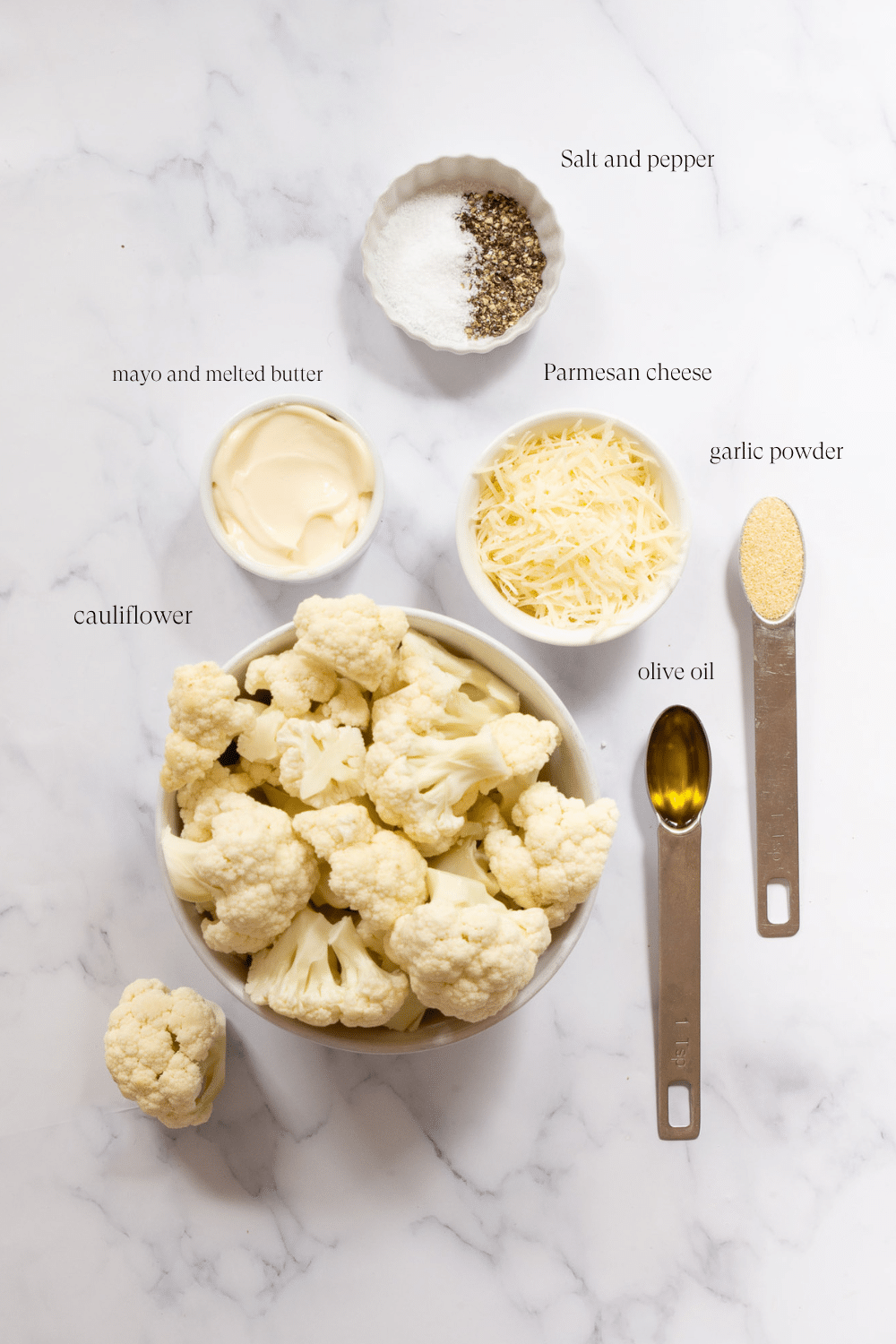 Ingredients for mashed cauliflower on a marble countertop