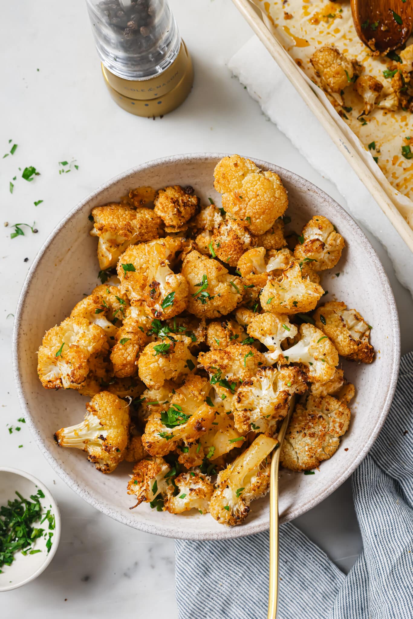 Close up of roasted cauliflower with parsley as garnish. 