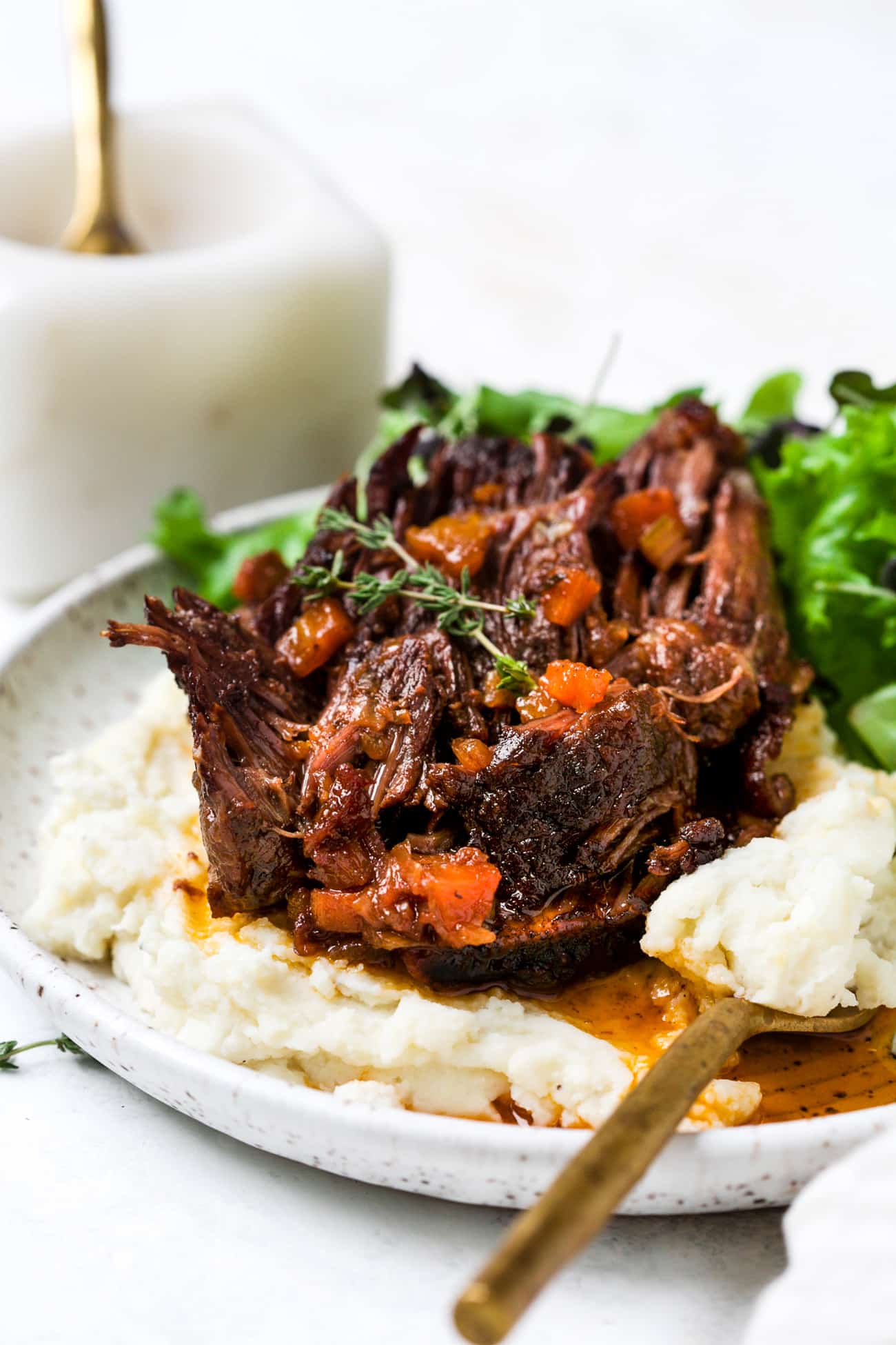 Red wine braised short ribs on a plate with mashed potatoes. 