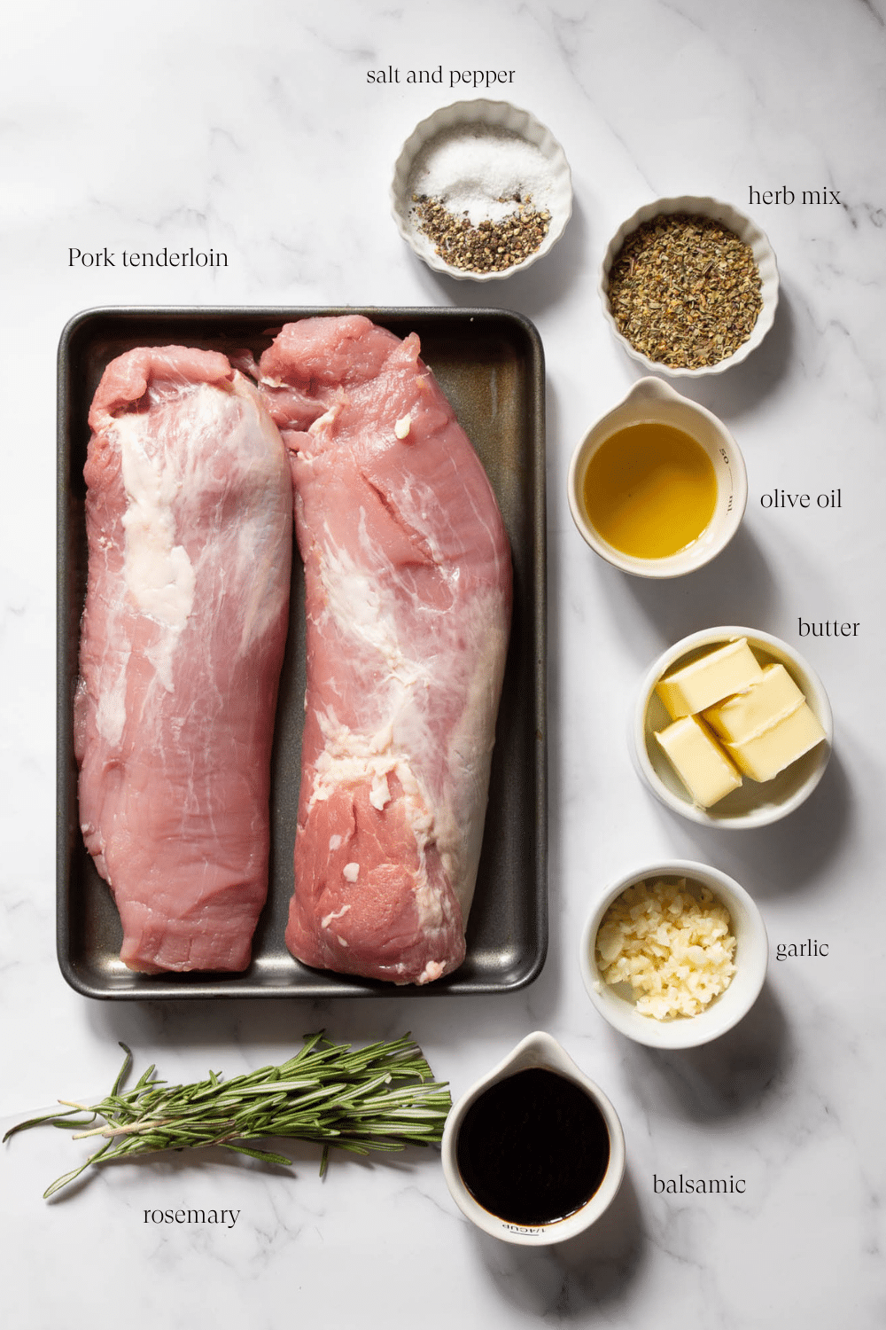 ingredients to make roasted pork tenderloin on a marble countertop 