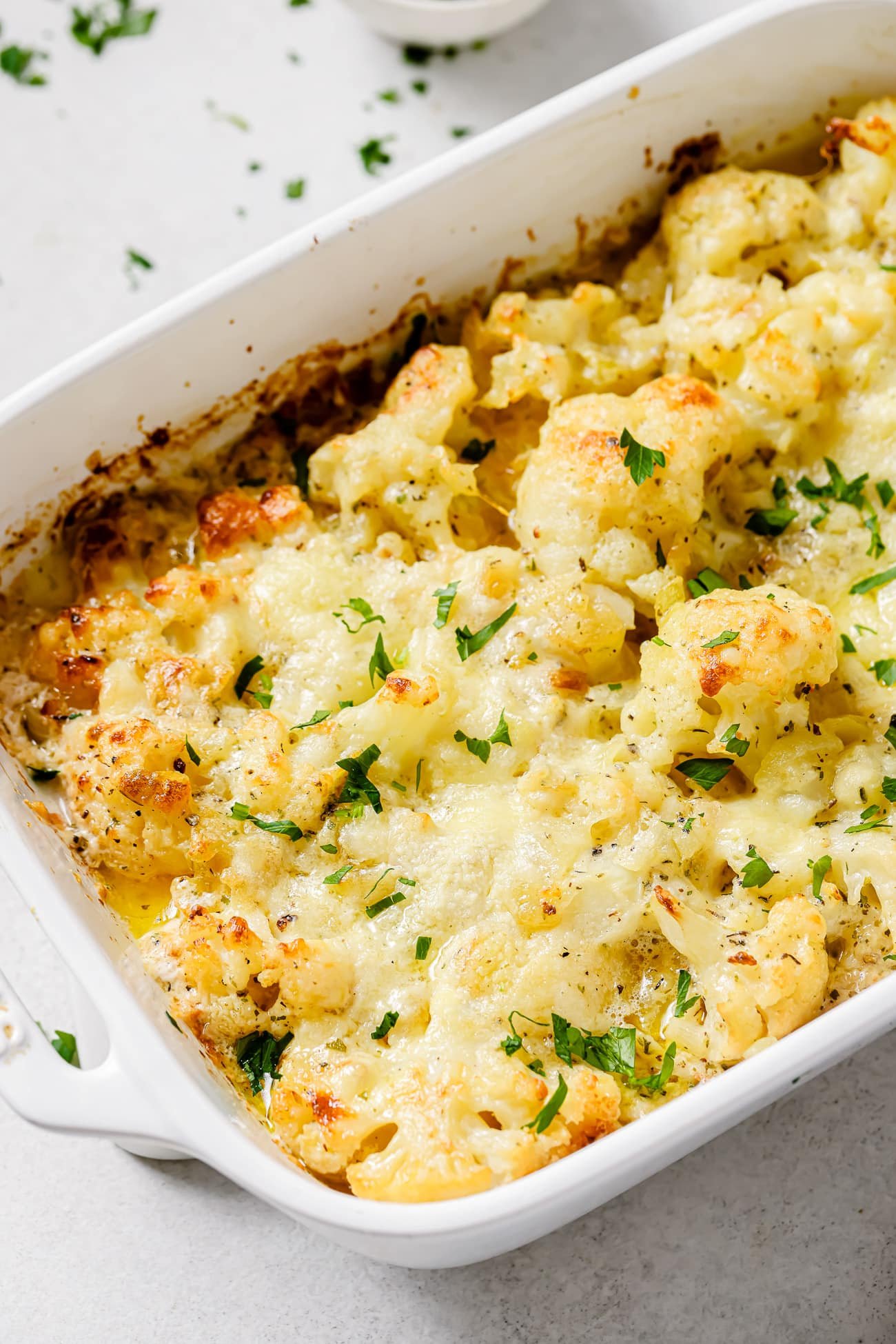 Close up of cauliflower au gratin in a baking dish.