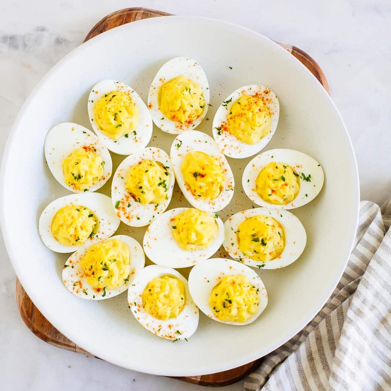 Overhead of Deviled eggs on a white plate. 