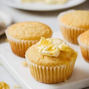 closeup view of cornmeal muffins on a marble platter.