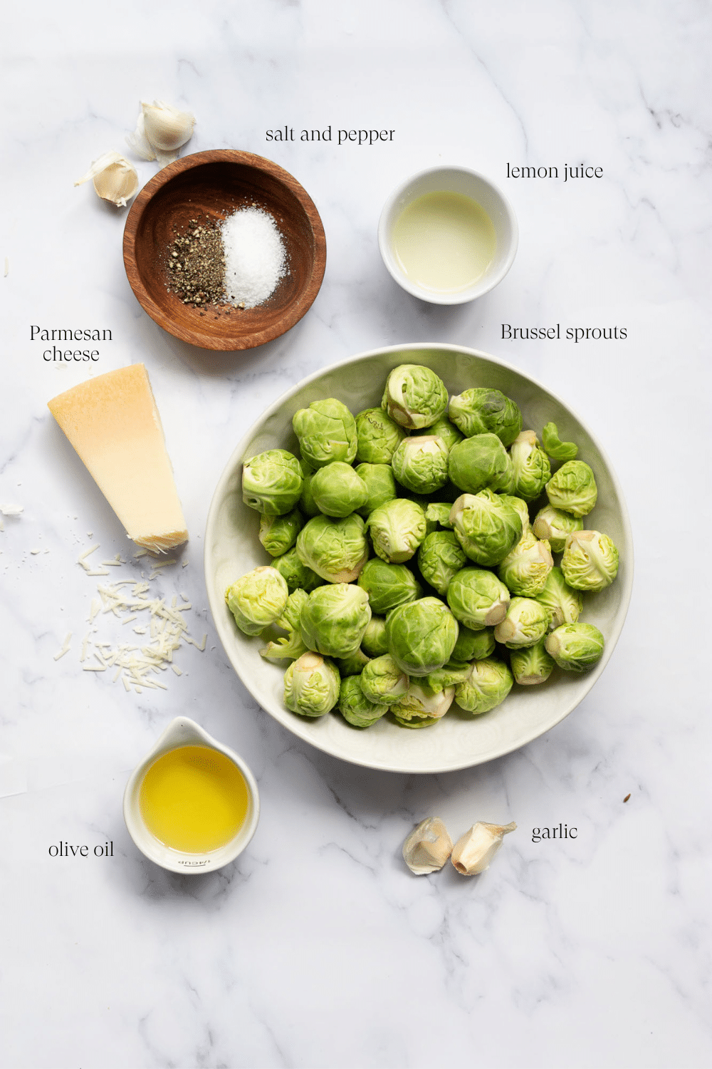 ingredients to make roasted brussel sprouts on a marble countertop