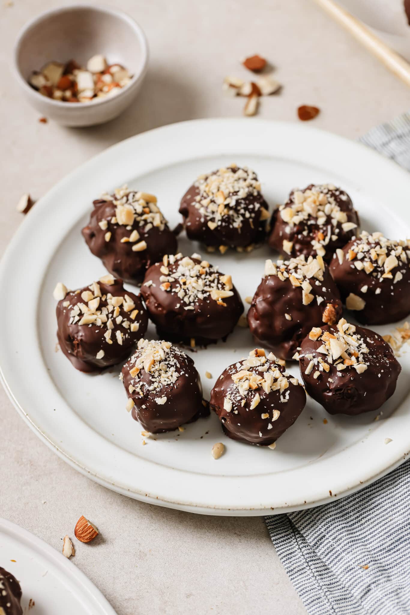 Close up of Almond Butter Chocolate Truffles on a white plate.