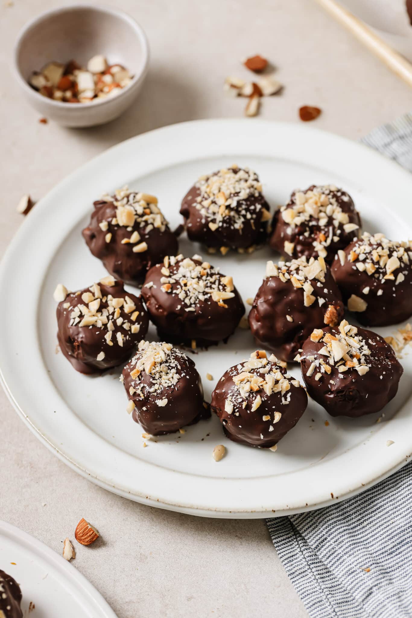 Close up of Almond Butter Chocolate Truffles on a white plate. 