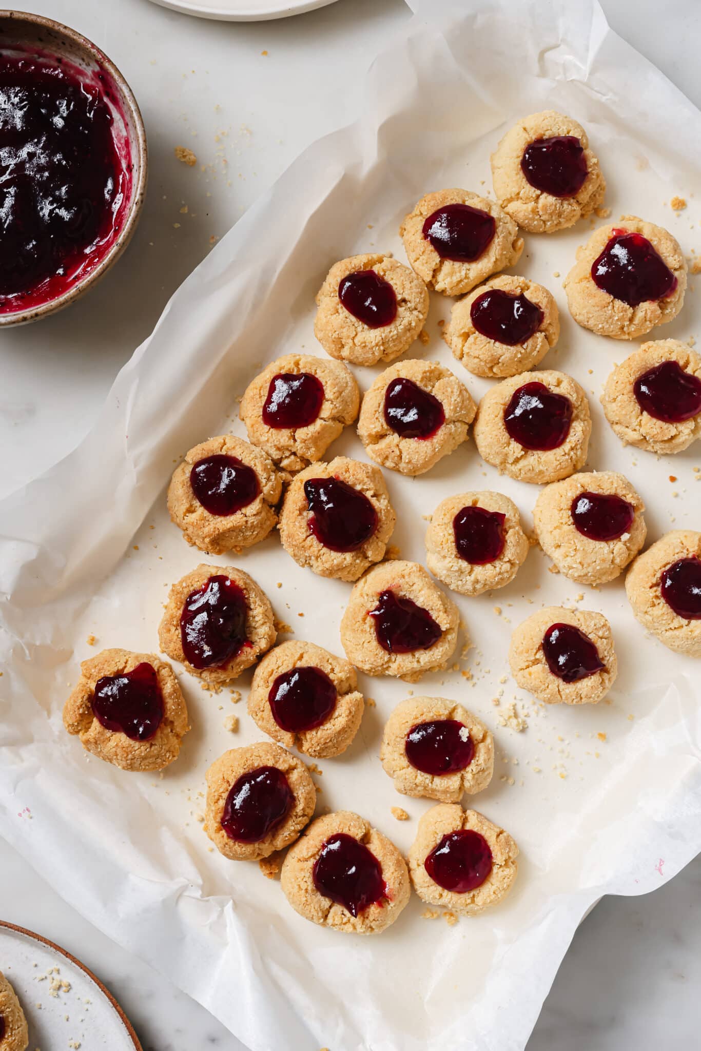 Cranberry Thumbprint Cookies on a baking sheet.  