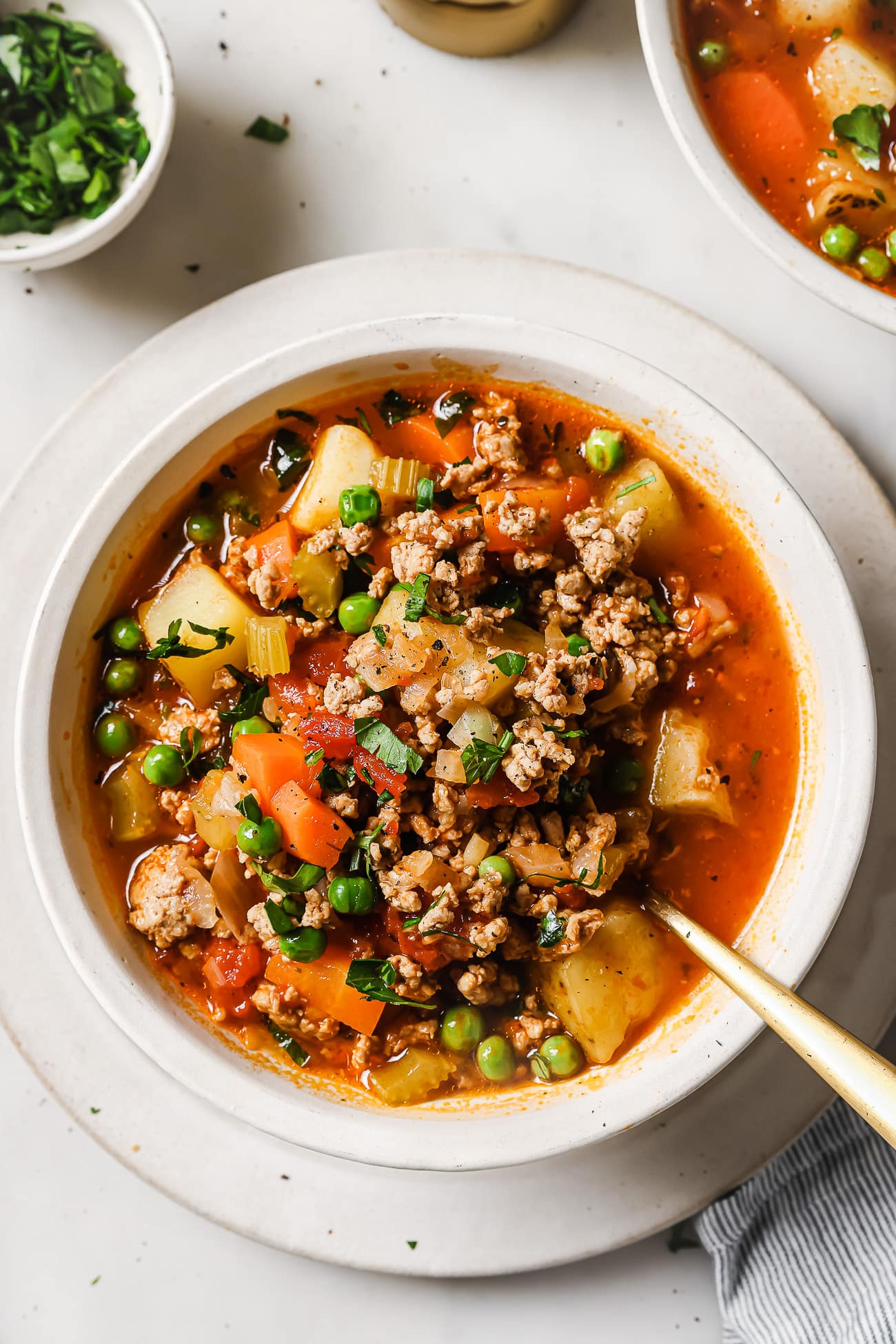 Ground turkey soup in a white bowl. 
