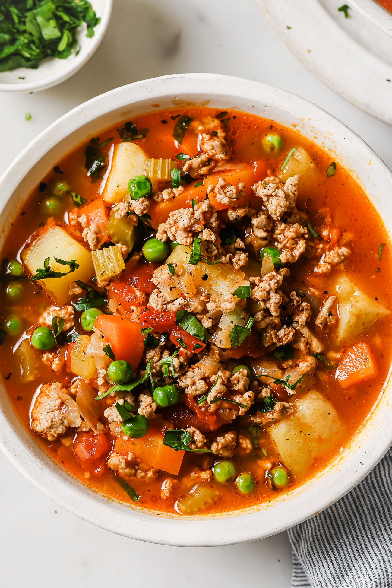 Ground turkey soup in a white bowl. 