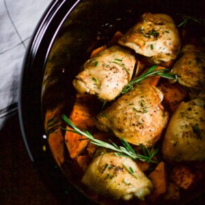 overhead view of chicken and sweet potatoes inside a crockpot