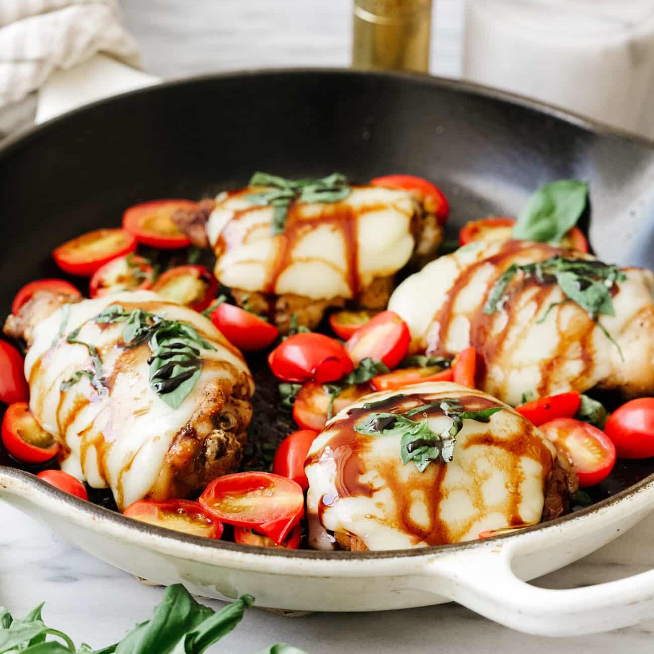 Closeup view of baked caprese chicken.