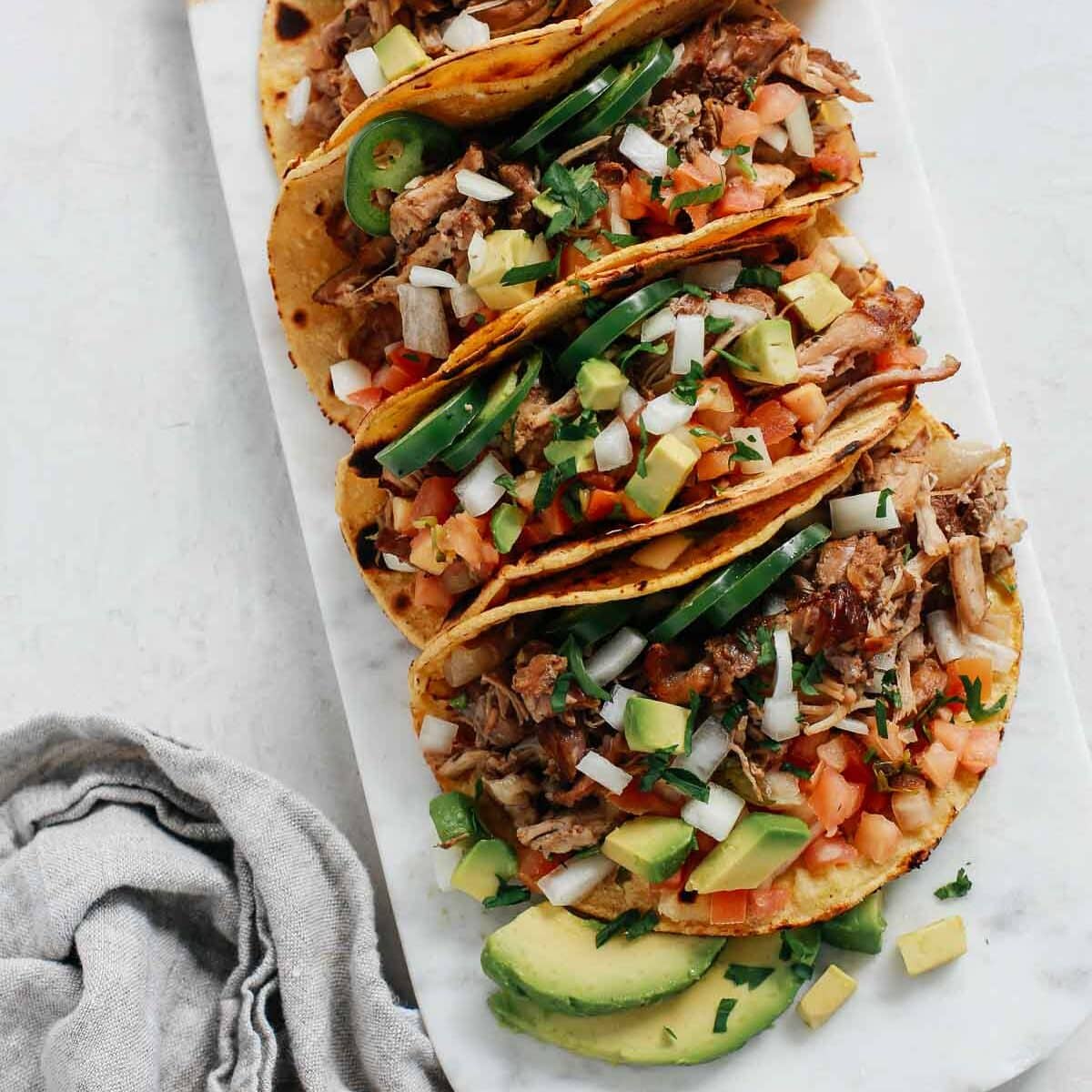 A tray of slow cooker carnitas tacos. One of my favorite date night dinner ideas.