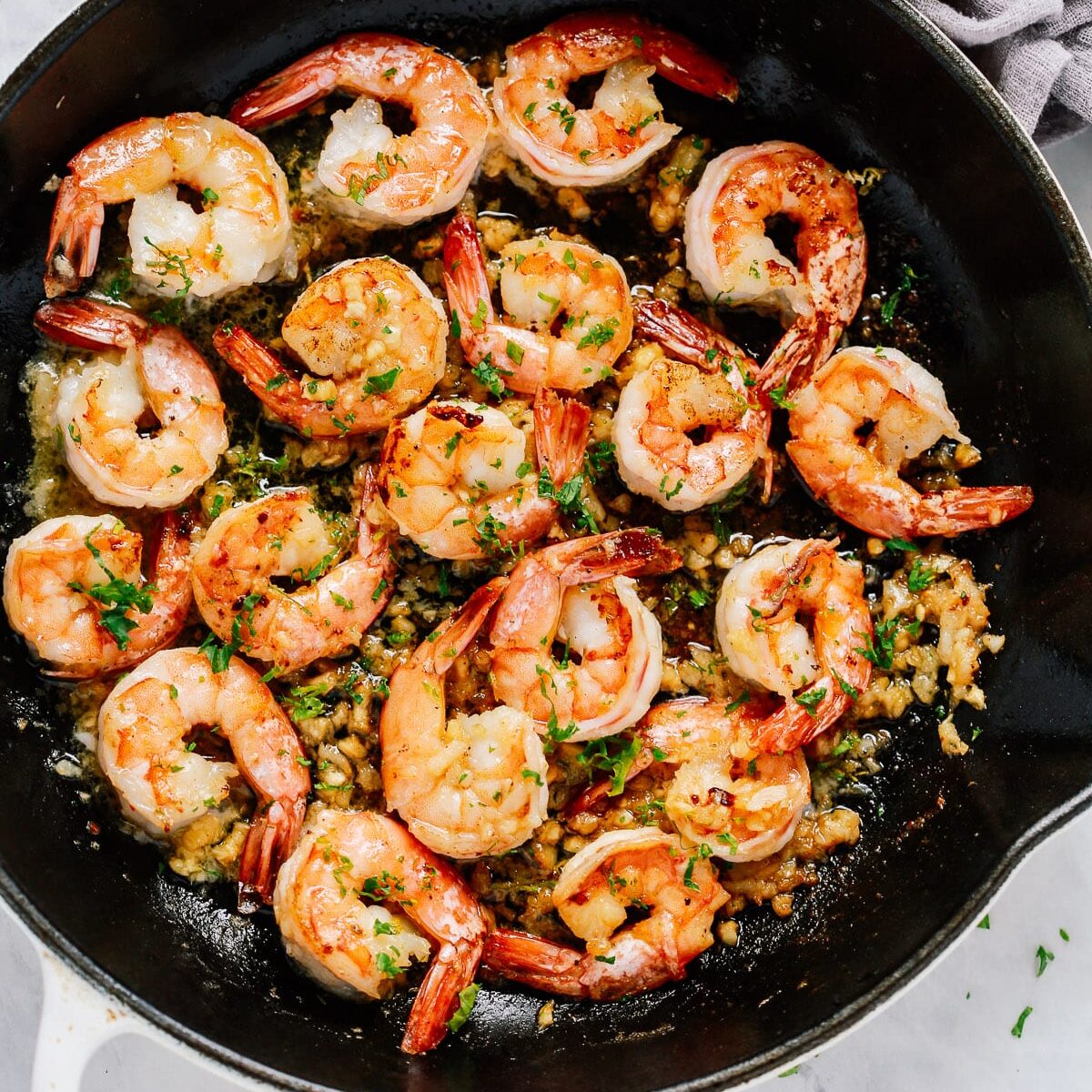 Overhead view of a skillet containing garlic butter shrimp. One of my favorite date night dinner ideas.