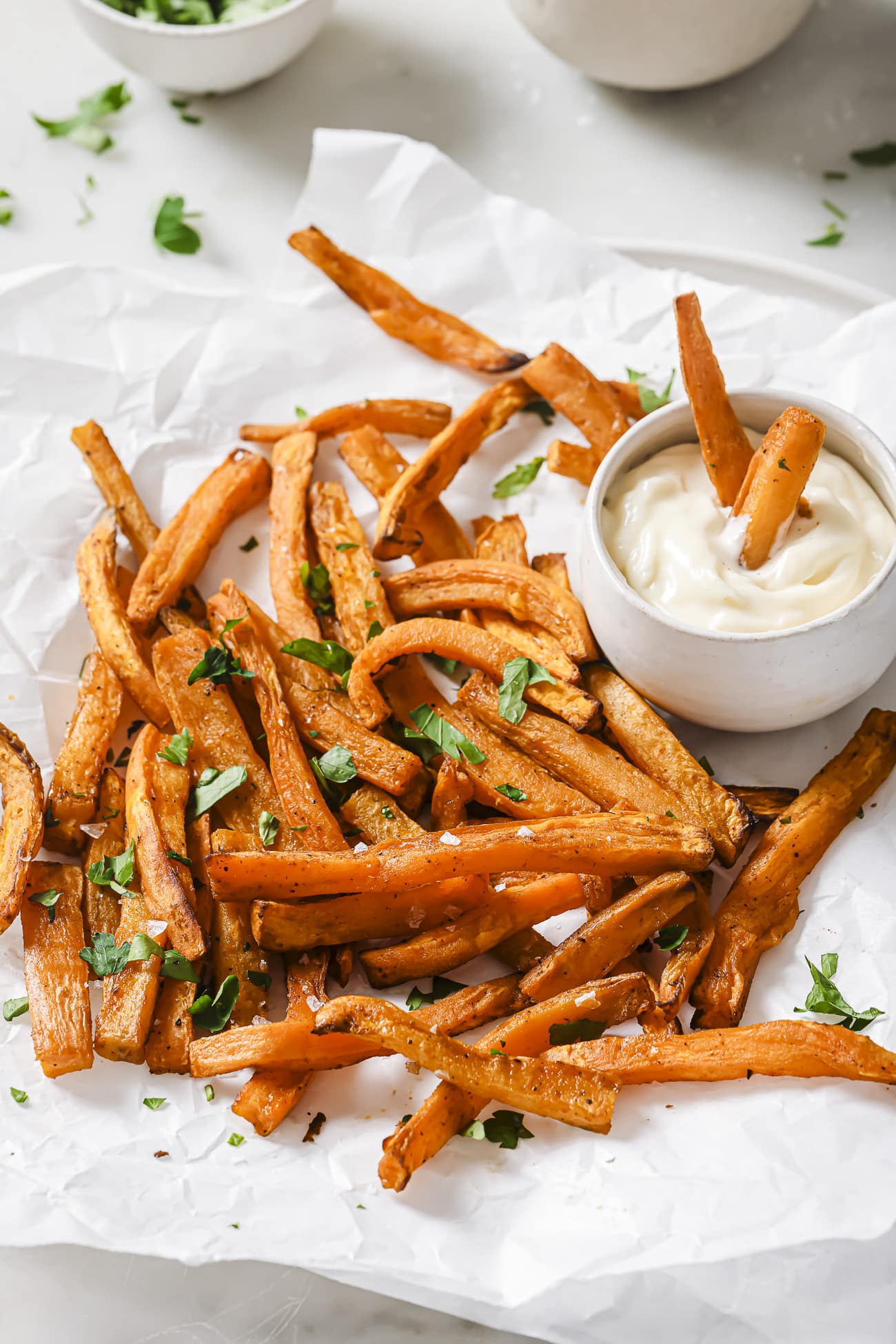 Air fryer sweet potatoes with dipping sauce on the side. 