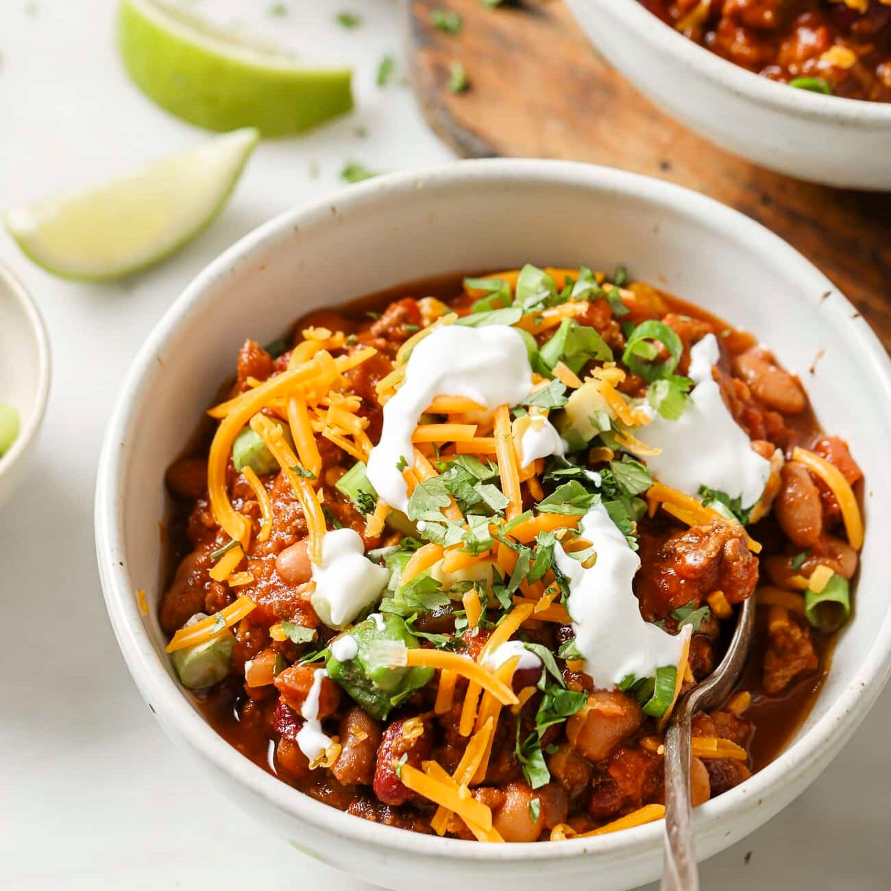 A bowl of slow cooker chili with toppings. One of my favorite date night dinner ideas.