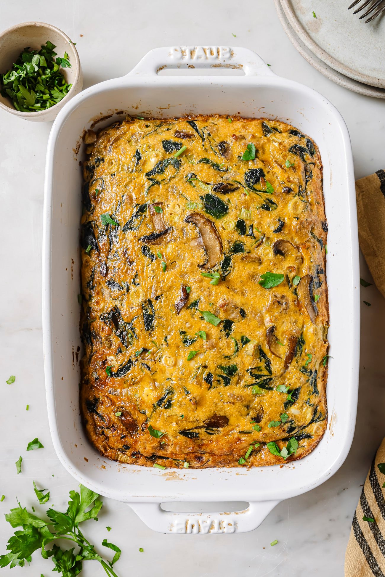 Spinach Mushroom Frittata in a white baking dish. 