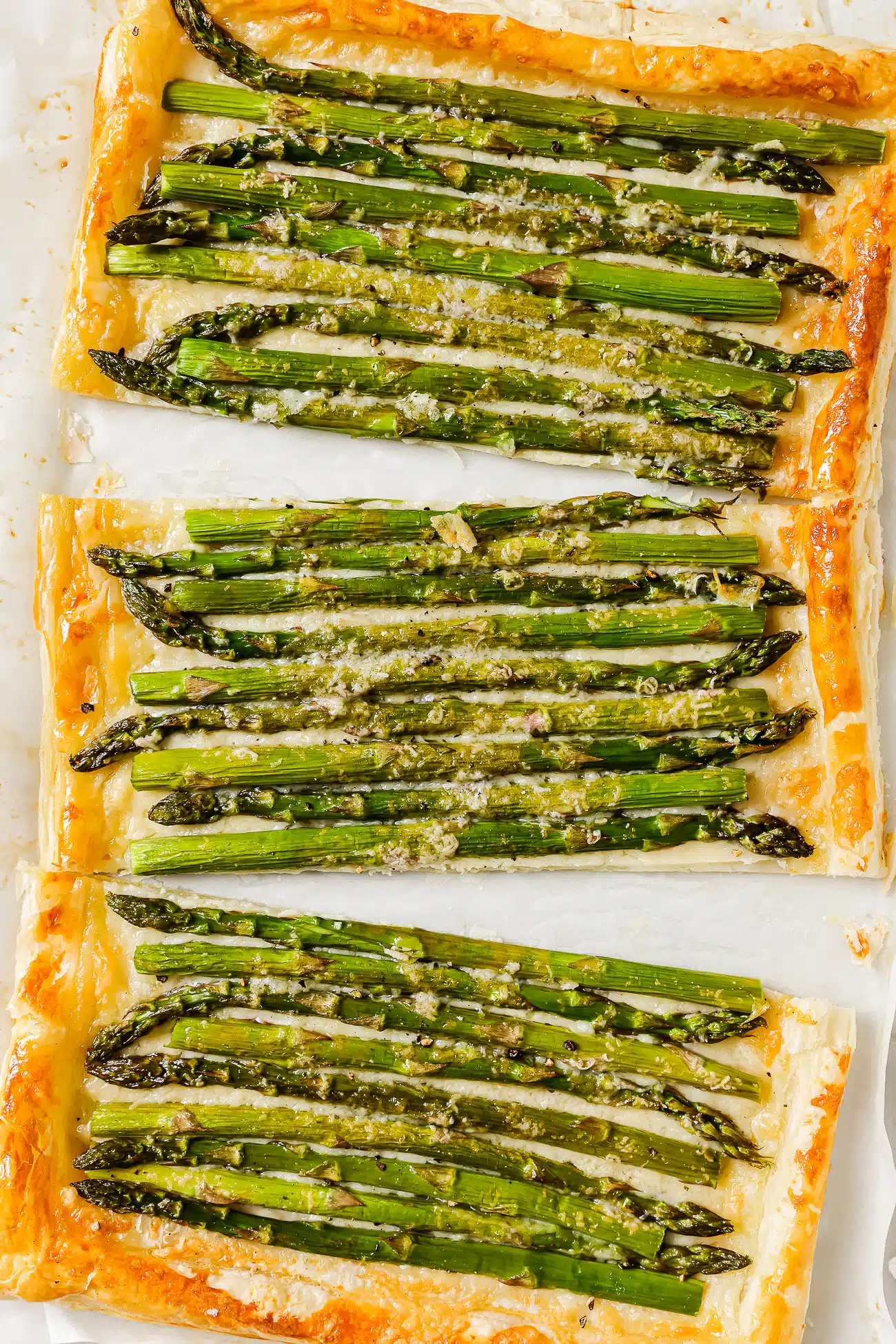 Close-up of an asparagus tart cut into slices. 