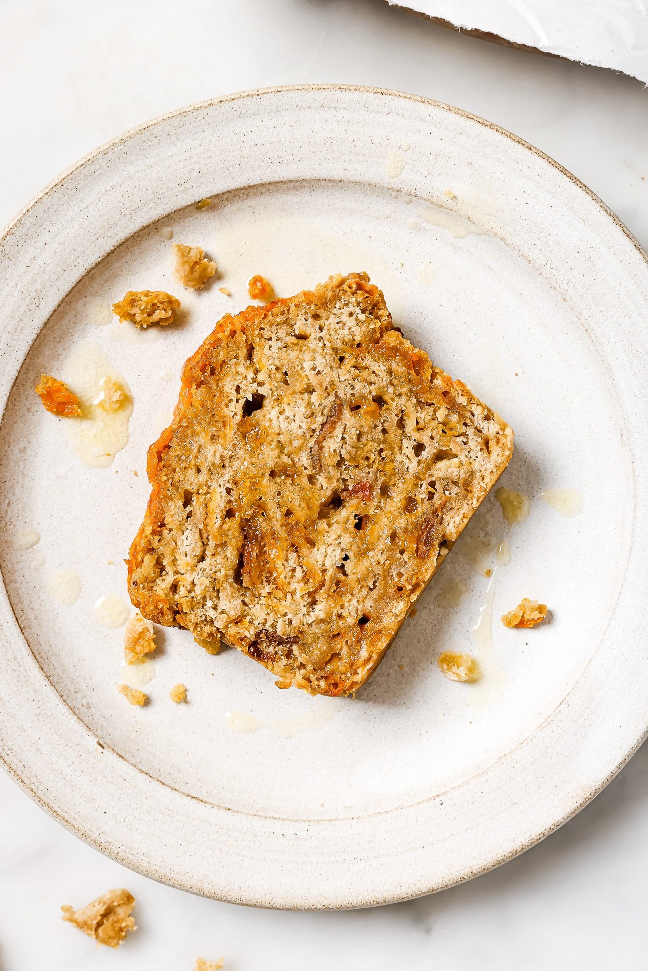 A slice of beer bread on a white plate.