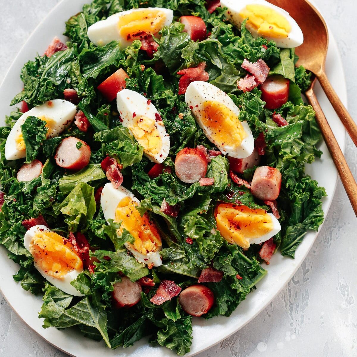 Kale breakfast salad in a white serving dish. 