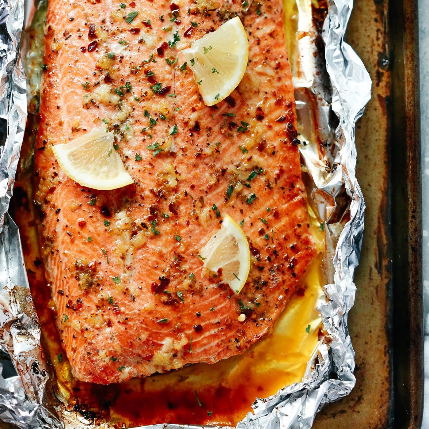 Overhead view of baked salmon in foil. 