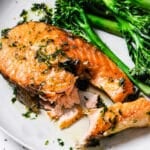 Garlic butter salmon steak in cast iron skillet, seared golden exterior